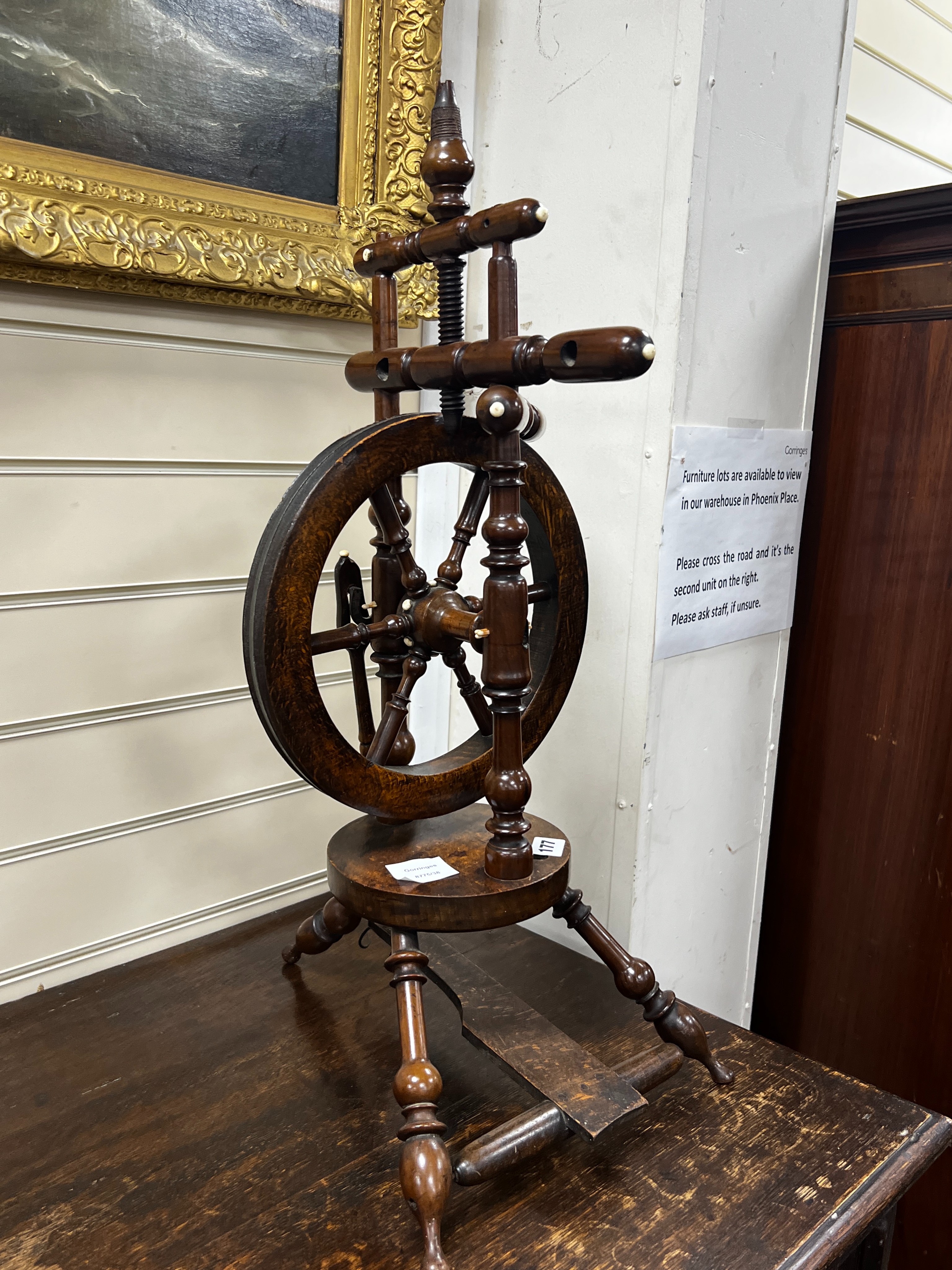 A provincial mahogany and beech spinning wheel, height 67cm